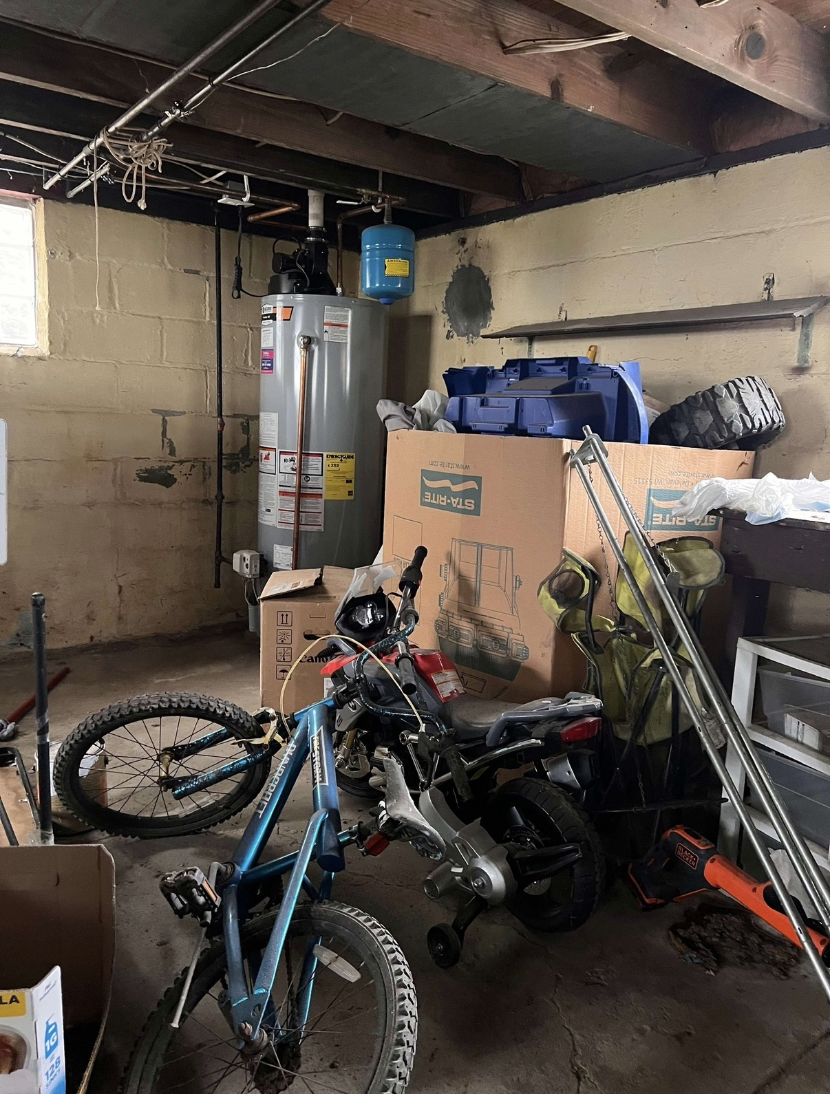 Basement garage packed with bikes, totes and boxes before a cleanout
