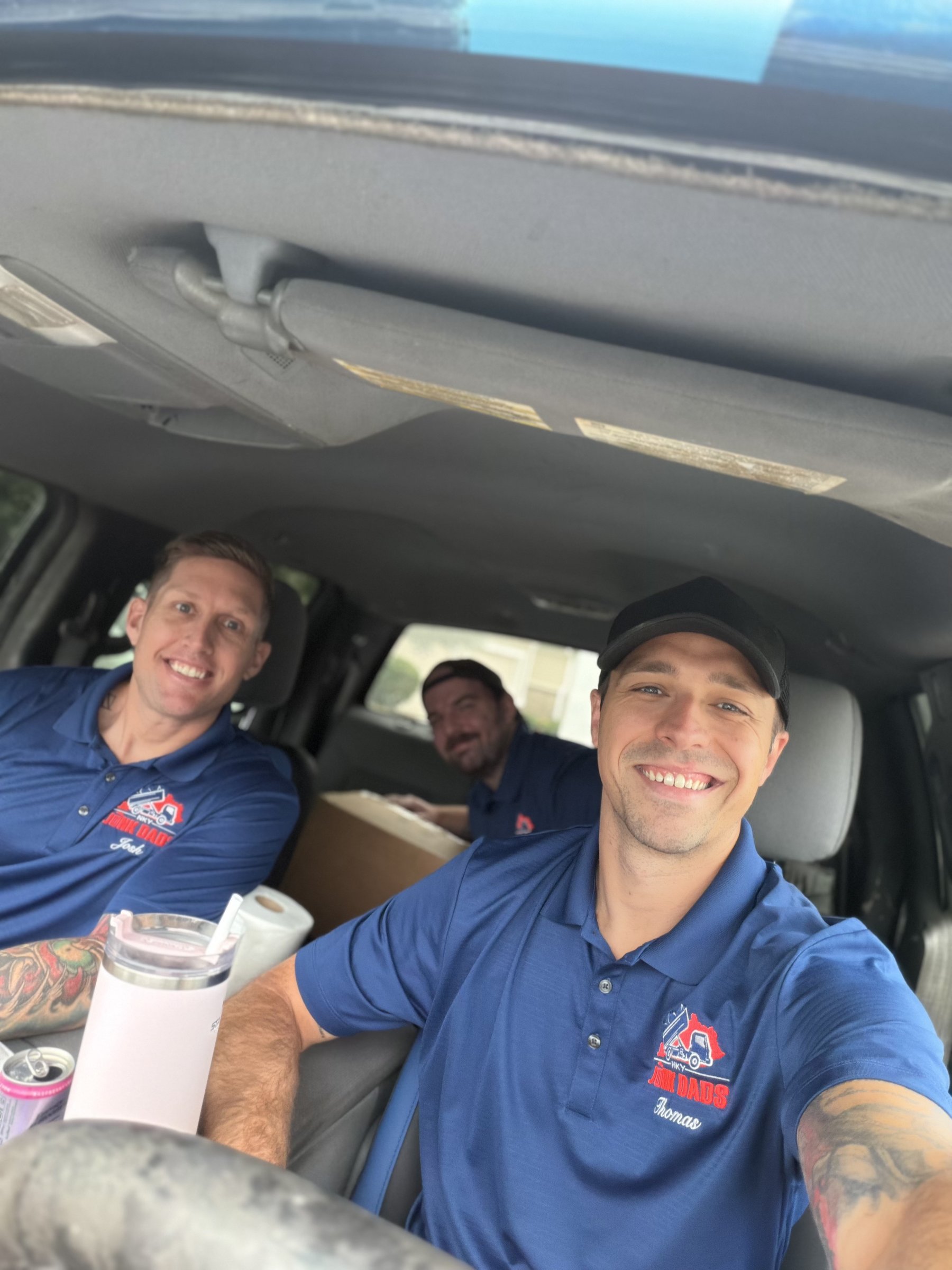 The Junk Dads crew together in their truck on the way to a job